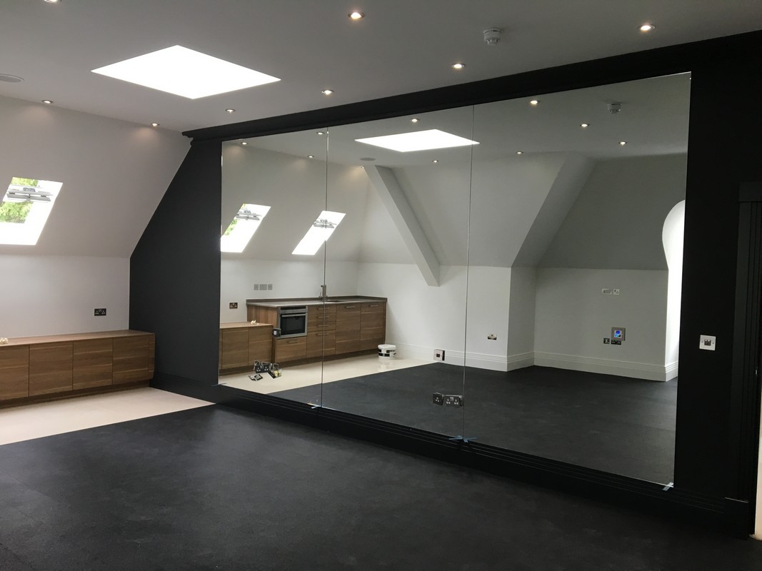 Frameless glass wall dividing loft conversion in Bracknell